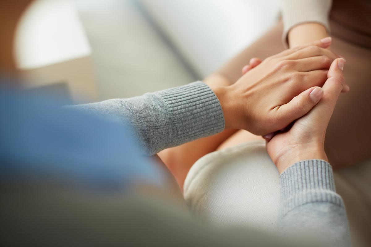 Hands of two people discussing ways to avoid rehab