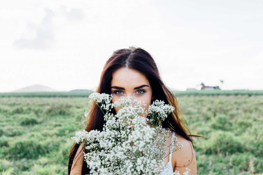 image of woman holding a bunch of wild flowers