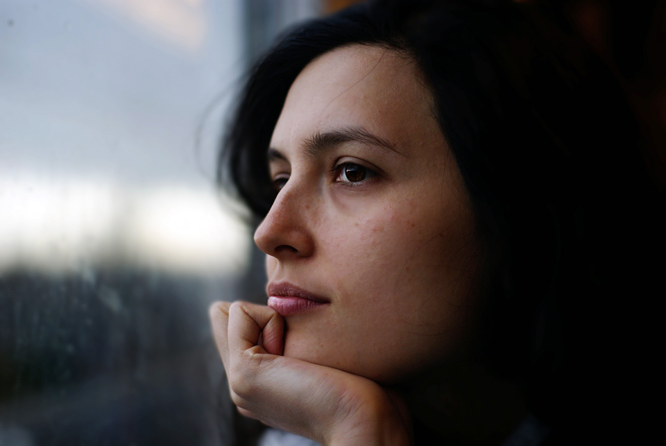 image of woman smiling looking out of window for blog article entitled "Sky's Story of addiction" for Gulf Breeze Recovery non 12 step holistic drug and alcohol treatment program