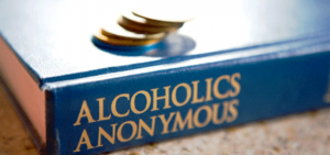 image of alcoholics anonymous book w coins