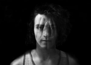 image of person with hands superimposed over face using double exposure technique for a blog article about Eye Movement Desensitization & Reprocessing (EMDR) for Gulf Breeze Recovery