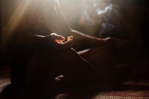 a person meditates in the warm sunshine in a program for holistic cocaine addiction treatment