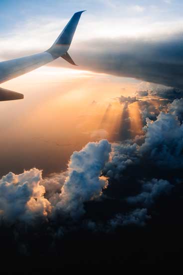 dramatic image of airplane over clouds for a blog article entitled "The Sun is Always Shining Somewhere" for Gulf Breeze Recovery's holistic non 12 step drug rehab