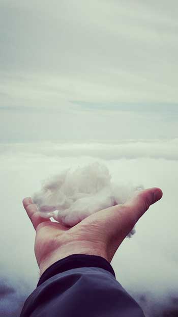 image of man holding a cloud in his hand for a blog article entitled "The Sun is Always Shining Somewhere" for Gulf Breeze Recovery's holistic non 12 step drug rehab