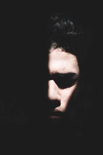 image of man in darkness for a blog article for Gulf Breeze Recovery entitled: Suicide and Substance Abuse – A Frightening Correlation