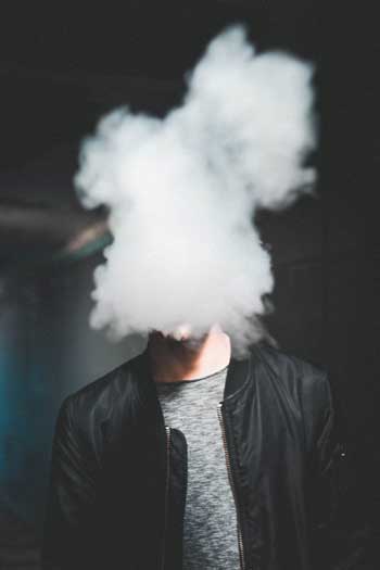 image of man’s face obscured in cloud for blog article entitled "Opioids and Other Drugs Can Be Addictive More Quickly than People Realize" for Gulf Breeze Recovery drug and alochol non 12 step holistic rehab