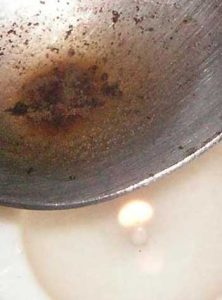 image of heroin cooking in spoon with candle flame for Gulf Breeze Recovery non-12 step holistic drug and alcohol rehab post article "Someone in the United States is most likely dying right now, this very moment, from a drug overdose."