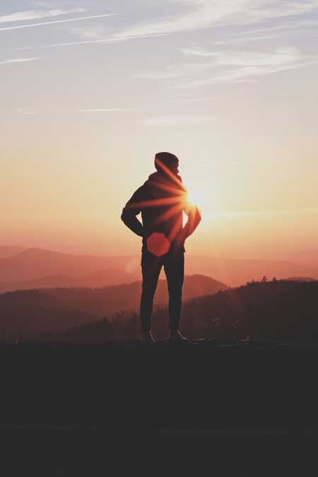 image of man standing before a setting sun experiencing tectonic personal growth for unscripted testimonial for Gulf Breeze Recovery non-12 step holistic drug and alcohol rehab in Florida