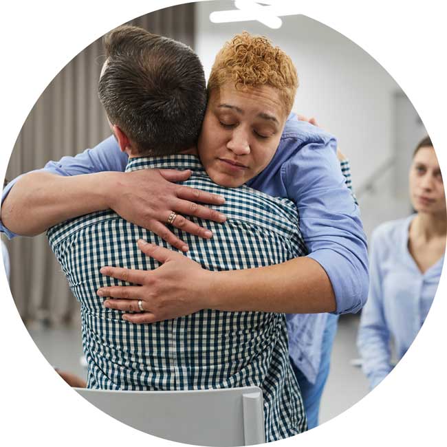 image of people hugging after a successful intervention. If you love someone who has drug or alcohol addiction and you think an intervention might be useful, contact Gulf Breeze Recovery 