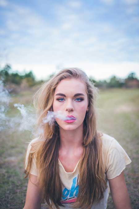 image of young person of college age using marijuana for news report of increased use for Gulf Breeze Recovery non-12 step holistic drug and alcohol rehab in Florida