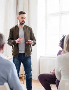 image of man speaking in group for Gulf Breeze Recovery on-12 step holistic drug and alcohol rehab