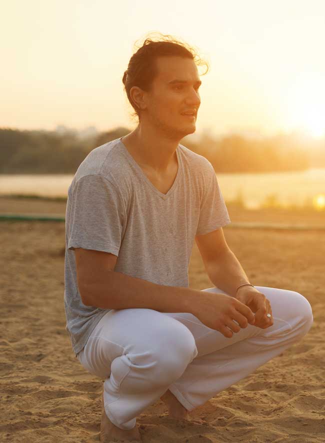 image of person thinking on beach at sunset for blog article for Gulf Breeze Recovery's non-12 step holistic drug and alcohol rehab in Florida