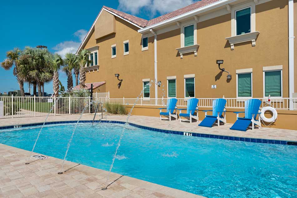 image of waterfront pool area, pool, and private fishing pier at Gulf Breeze Recovery's non-12 step alcohol treatment center in Florida