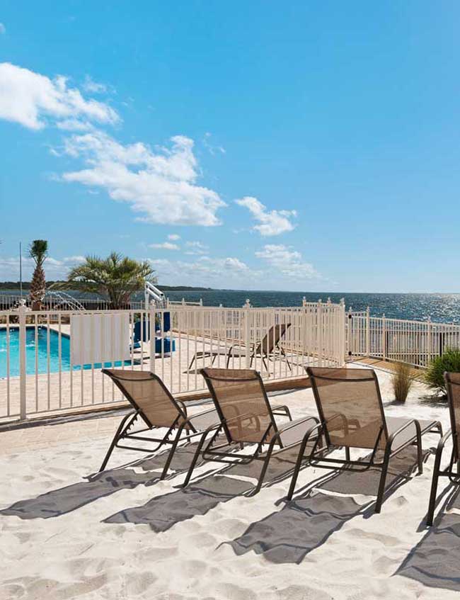 image of private beach, pool, and private fishing pier at Gulf Breeze Recovery's non-12 step alcohol treatment center in Florida