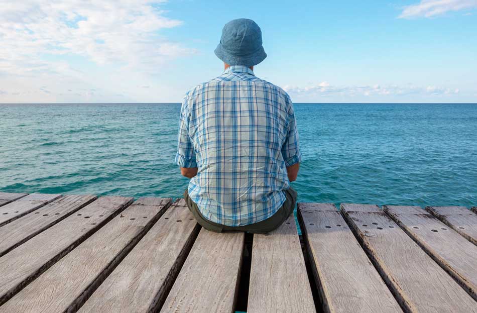 image of man enjoying quiet time on private pier at Gulf Breeze Recovery drug and alcohol rehab in Florida