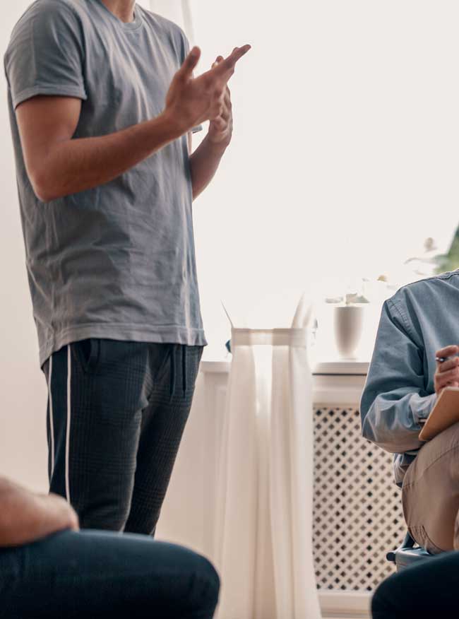 image of young man sharing in group therapy