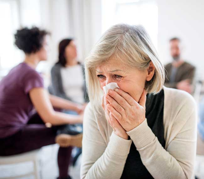 portrait of senior woman crying at therapy