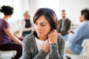 image of woman in therapy group for addiction treatment