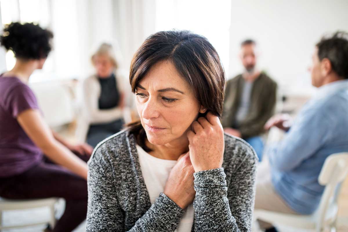 image of woman in therapy group for addiction treatment