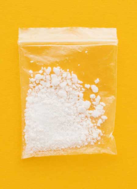 image of bag of meth on yellow background