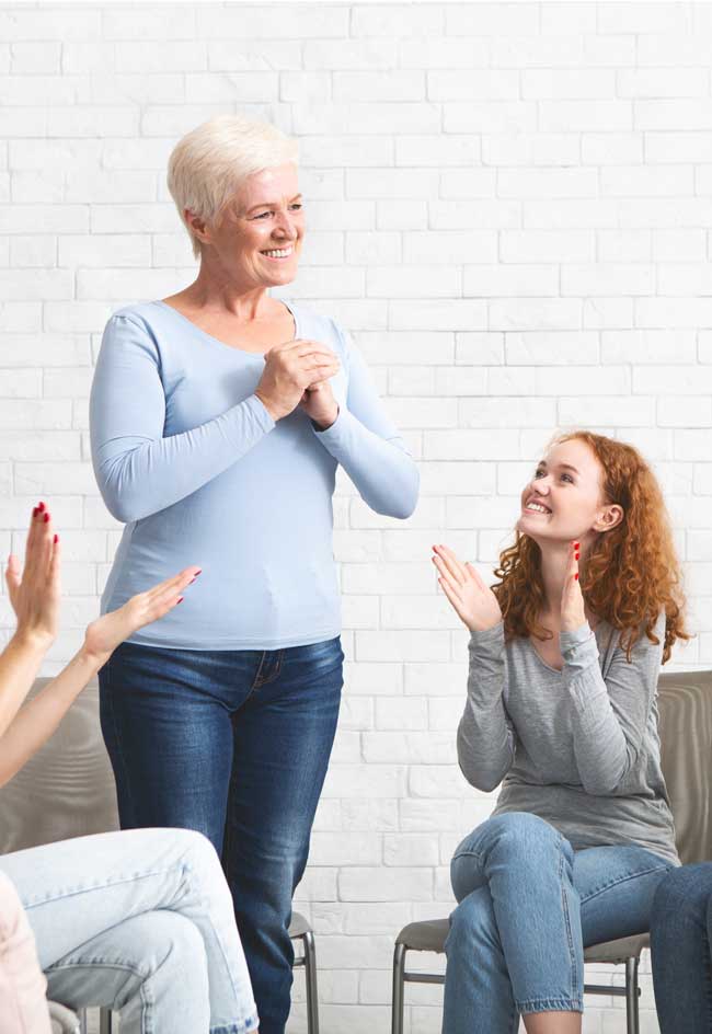 attractive senior woman in group therapy