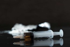 image of syringe and drugs