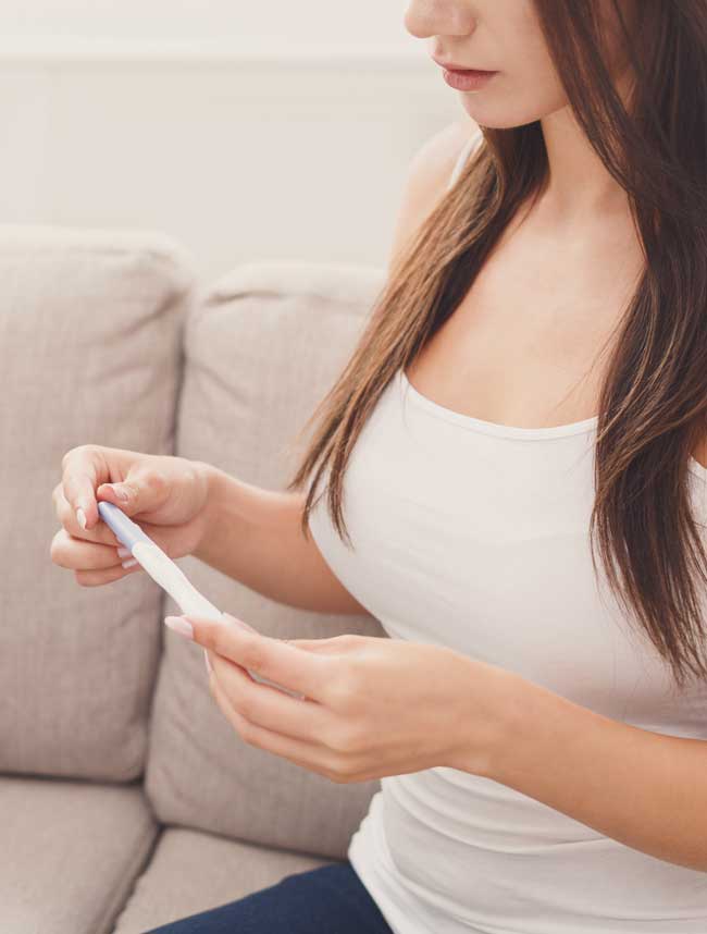 image of woman waiting for pregnancy test results