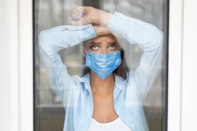 image of woman wearing mask indoors during quatantine