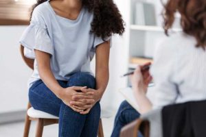 image of woman sharing PTSD related trauma with therapist
