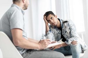 Young man in counseling for Long-term Residential Treatment is the Best Option - Especially During a Pandemic