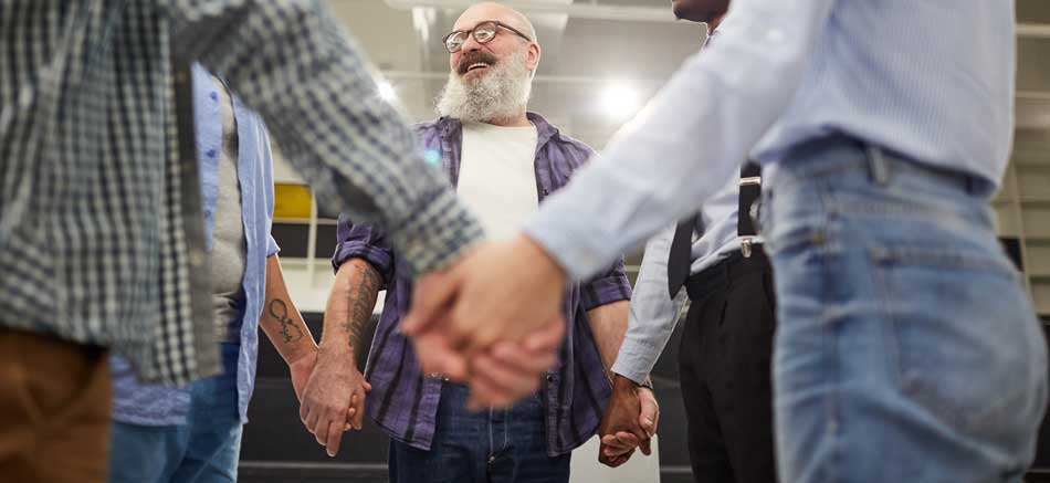 smiling-senior-man-in-support-circle-950px-2