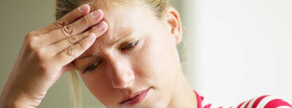 young-woman-feeling-headache-looking-at-computer-950px