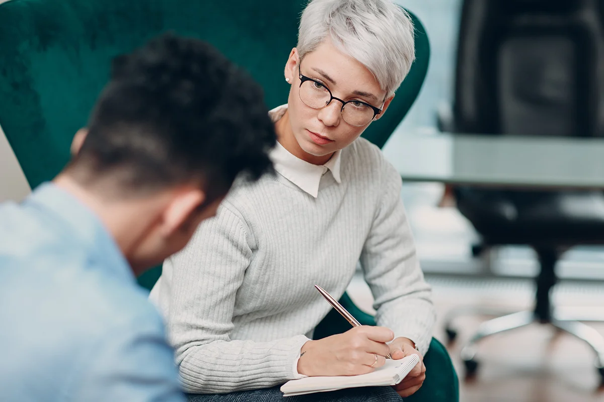 Counselor listening to man