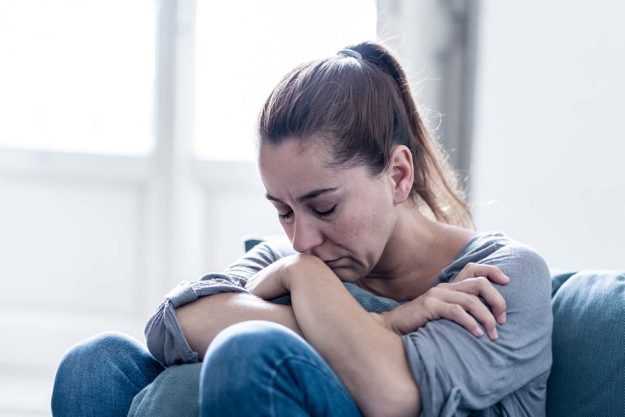 a woman displays alcohol addiction signs