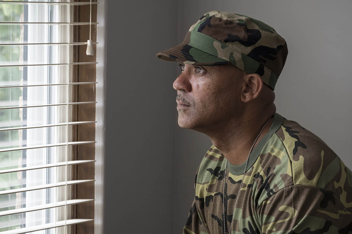 soldier looking out window needing substance abuse and veterans