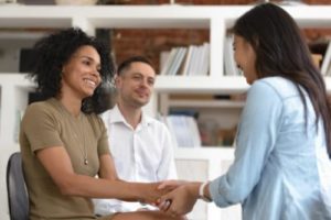 female therapist meeting with a couple to explain the intensive outpatient program for addiction treatment