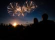 silhouette of couple watching night time fireworks show and following tips to enjoy a sober fourth of july