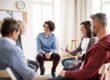 a diverse group participates in a group therapy activity
