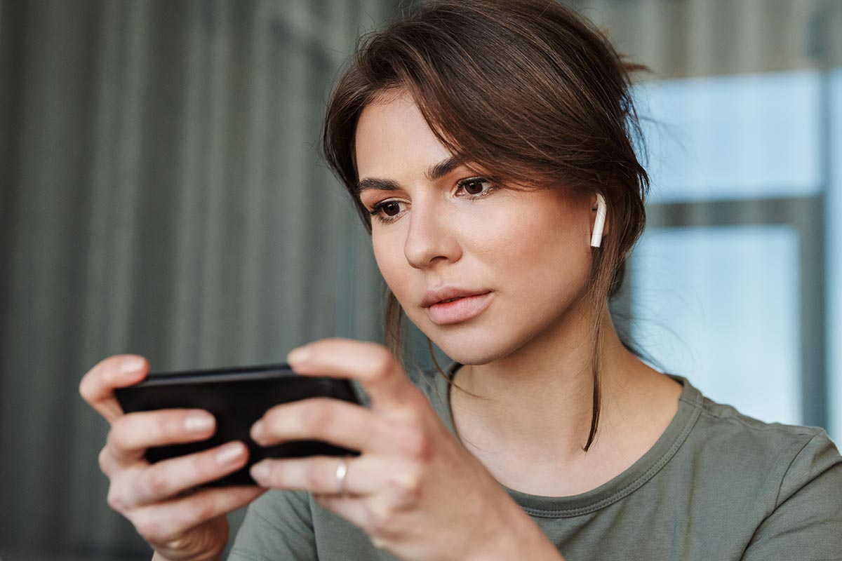 Woman handling a small device while learning how to detox from cocaine