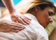 Woman receives a back massage while wondering, "What is holistic treatment?"
