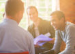Participants of a men's rehab program talking to each other