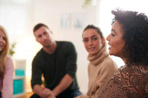 People in a session benefiting from various group therapy techniques