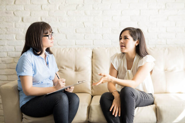 Woman learning the answer to the question what is a relapse program in individual therapy at a treatment center