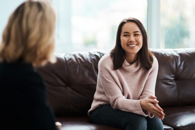 Happy person in session with counselor after getting sober and participating in aftercare treatment