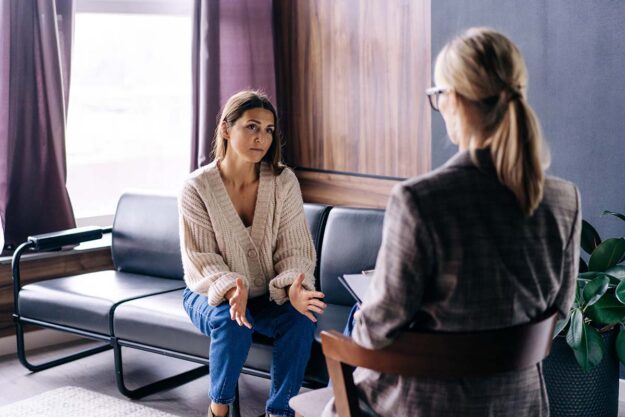 Concerned client and counselor discussing treatments for opioid addiction