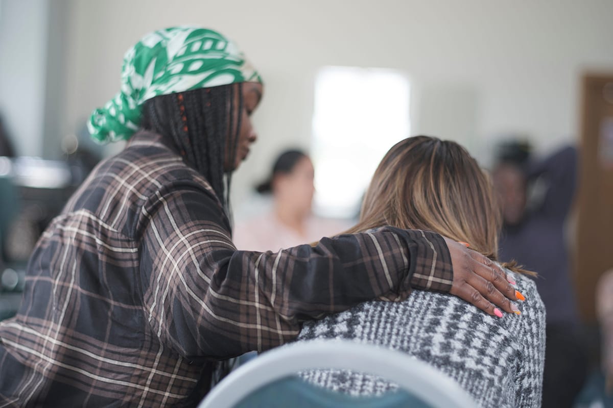 person comforting someone else in group therapy as part of prescription addiction treatment gulf breeze fl