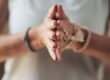 person pressing hands together in meditation after finding holistic rehab in Florida