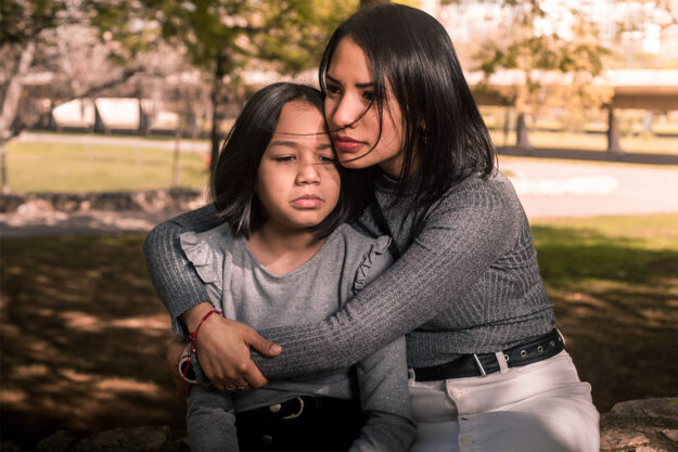 A woman holding a child and wondering, how can drug abuse affect your family?