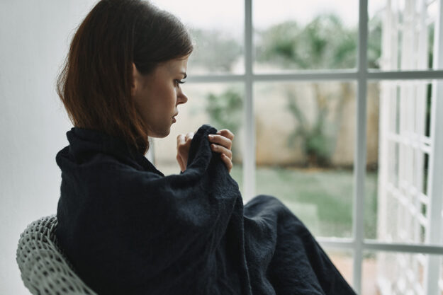 A woman thinking about her signs of opioid withdrawal