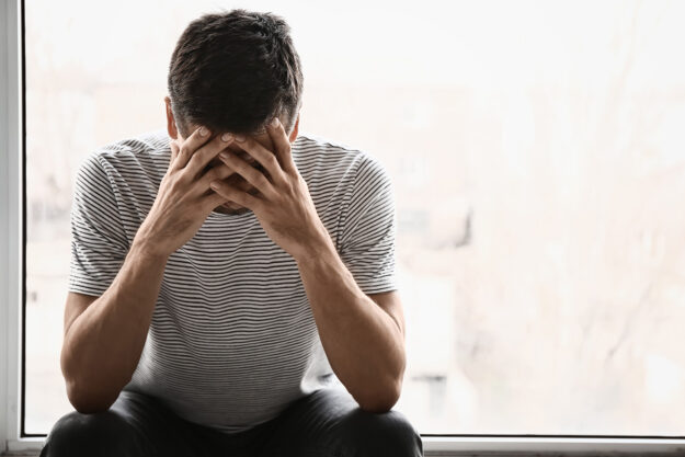 A man thinking about his signs of opioid intoxication